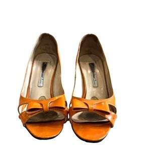 Brian Atwood well loved orange patent bow heels